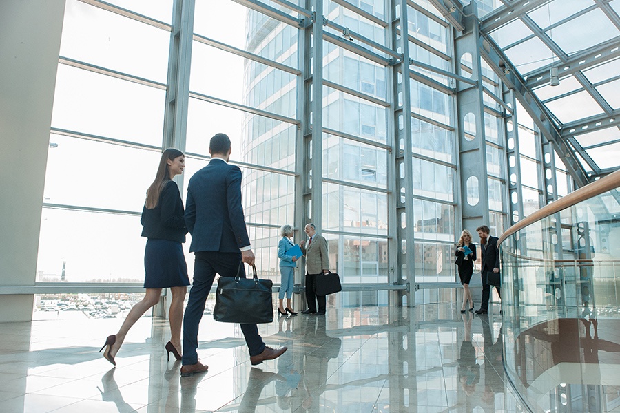 Business Insurance - Business People Walking in a Glass Building